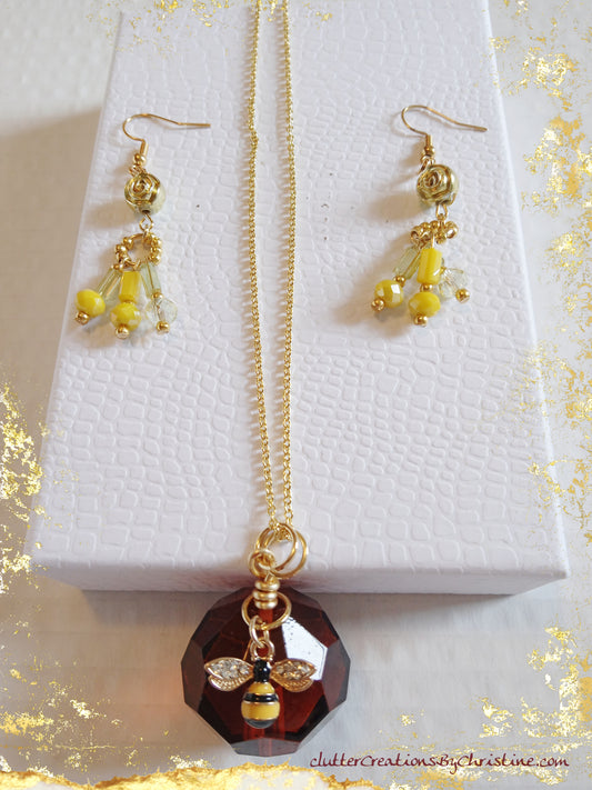 Bumble Bee Glass Beehive Pendant and matching hand-crafted earrings. Adorned with a variety of shiny and colorful beads, and featuring a water-resistant 14k gold plated (22inch )chain, this set exudes elegance and charm!