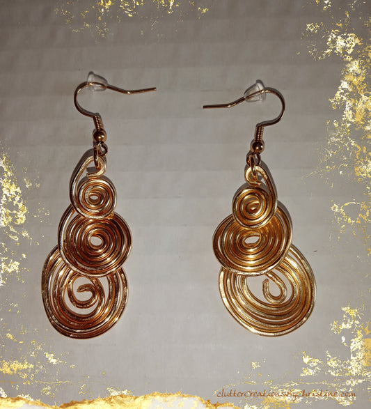 Handmade 3 tier spiral bangle earrings. Made with tarnish-resistant copper wire and 18 kt gold plated hooks, they exude luxury and lasting beauty.