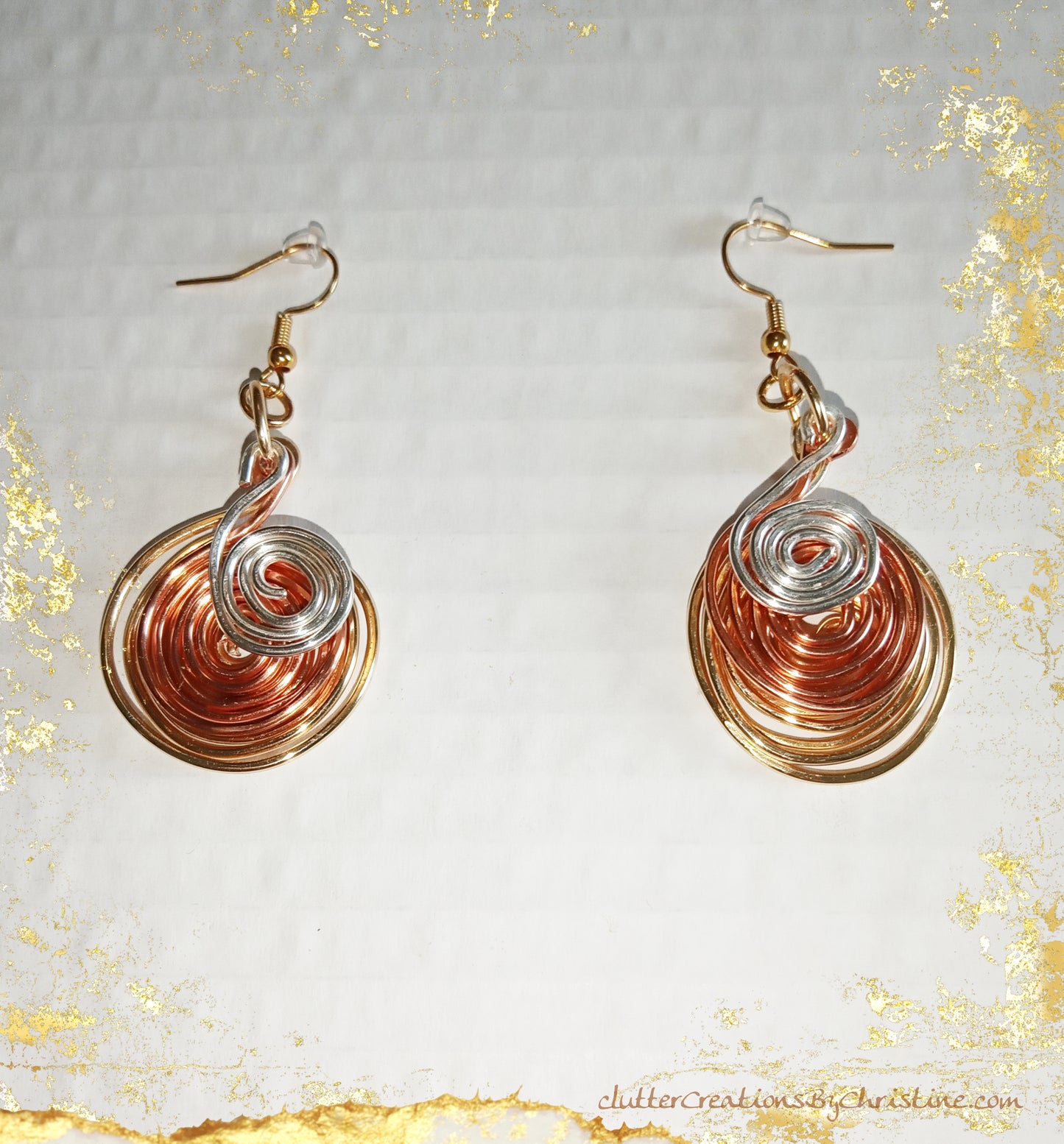 Handmade One-of-a-kind earrings feature a spiral design in gold, silver, and copper colors, creating a fun and stylish look. Crafted with tarnish-resistant copper wire and 18 kt gold plated hooks.