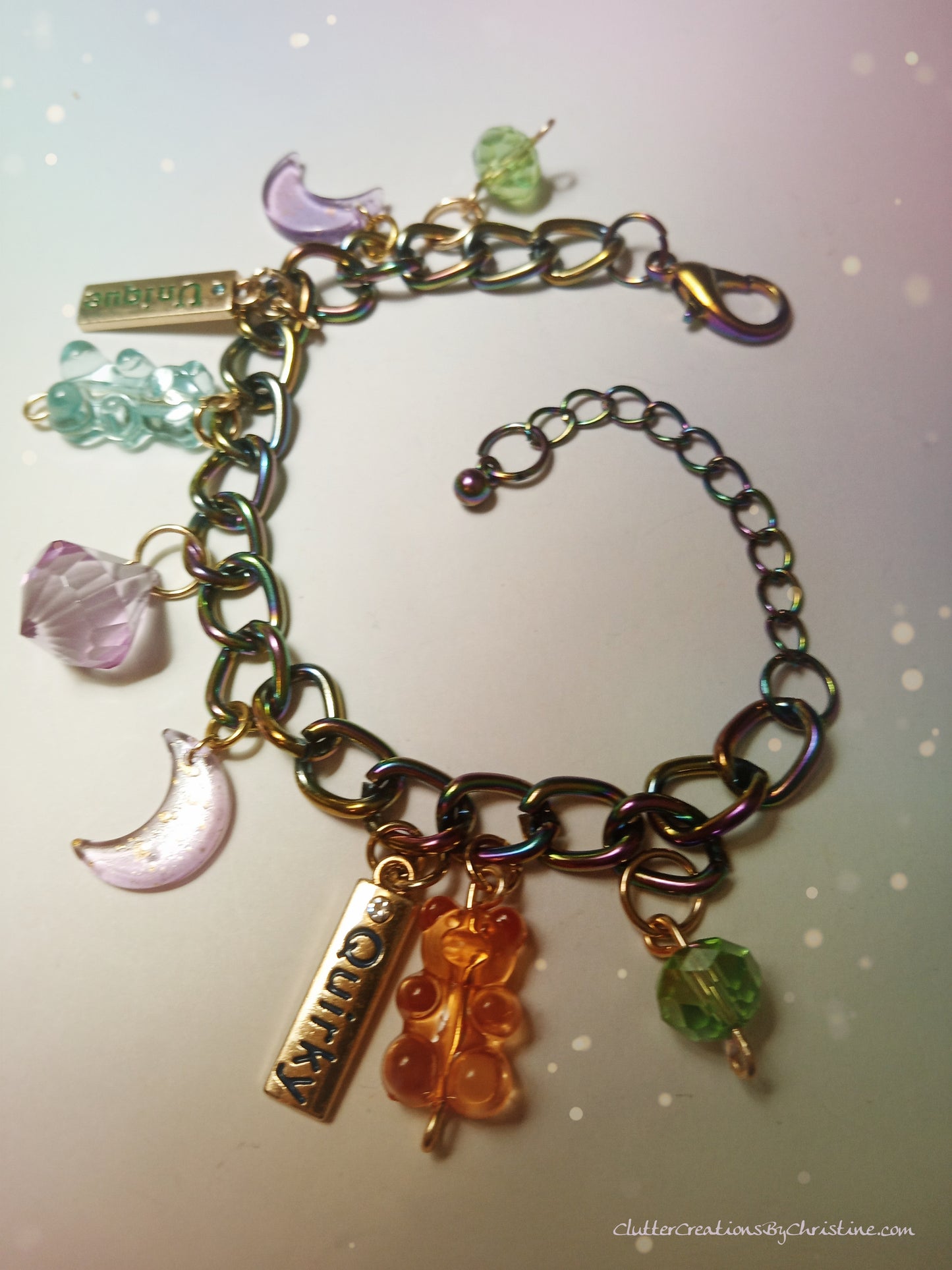 one-of-a-kind, playful multi-color charm bracelet. Made with 9 creative and fun charms, each one as unique as you. Includes an extender to fit all sizes