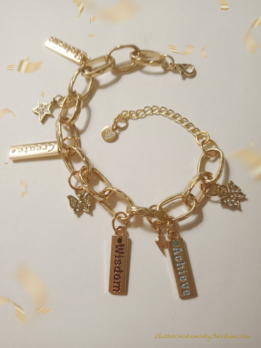 Golden Dreams Charm Bracelet. Handmade with love and creativity, this unique and memorable design features 8 inspirational charms and a beautiful gold link extender to fit any wrist size.